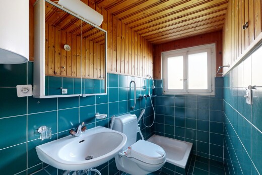 full bath with a shower stall and tile walls
