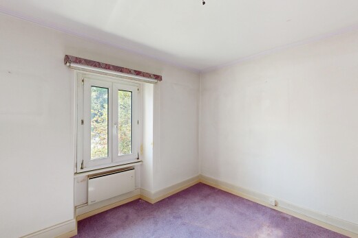 empty room with light carpet and radiator heating unit