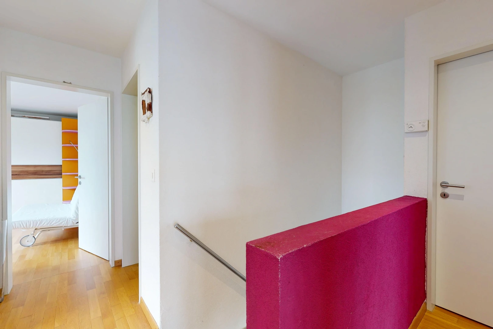 hallway featuring light wood-style floors and an upstairs landing