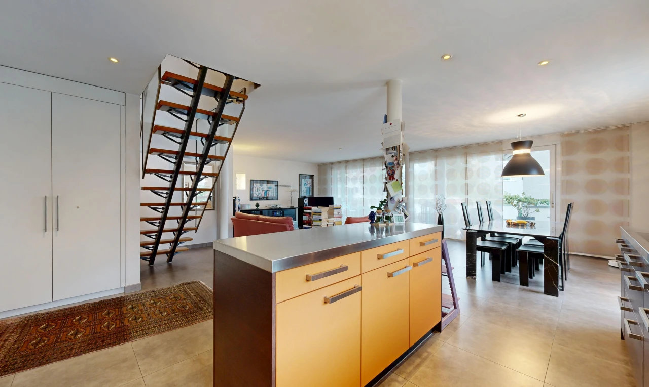 kitchen featuring stainless steel counters, a kitchen island, open floor plan, hanging light fixtures, and modern cabinets