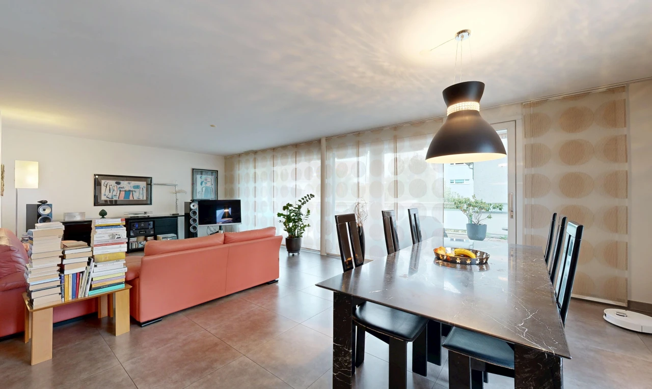 living / dining area with pendant lighting and wallpapered walls