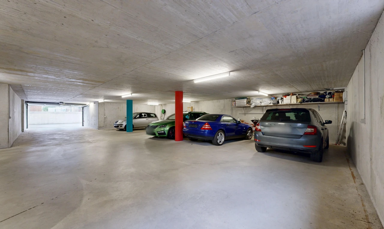 view of parking with a parking deck