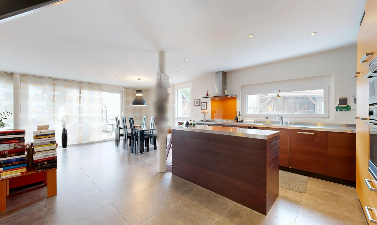 kitchen featuring a center island, pendant lighting, stainless steel countertops, and modern cabinets
