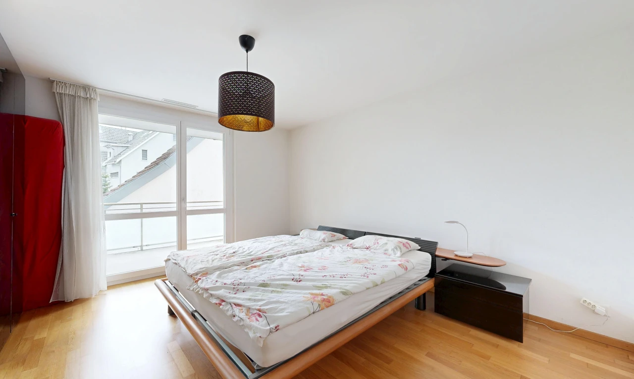 room / bedroom featuring hanging light fixtures and light wood-style floors