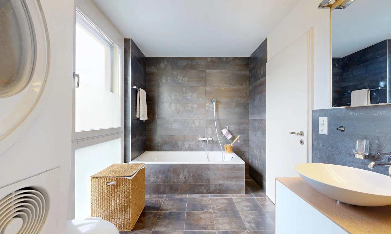 full bath featuring a bath, vanity, and tile walls