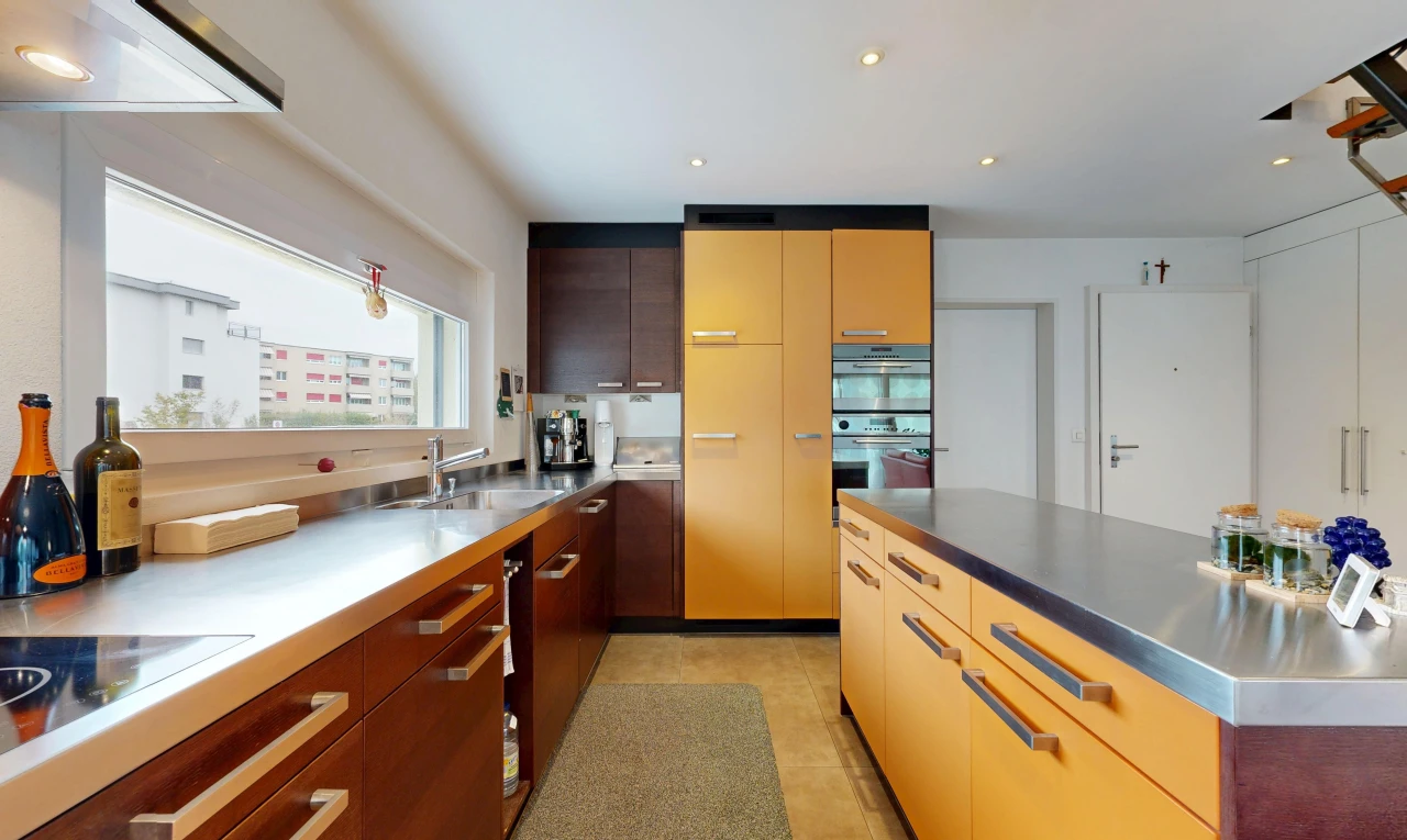 kitchen with stainless steel counters, recessed lighting, modern cabinets, two tone cabinetry, and extractor fan