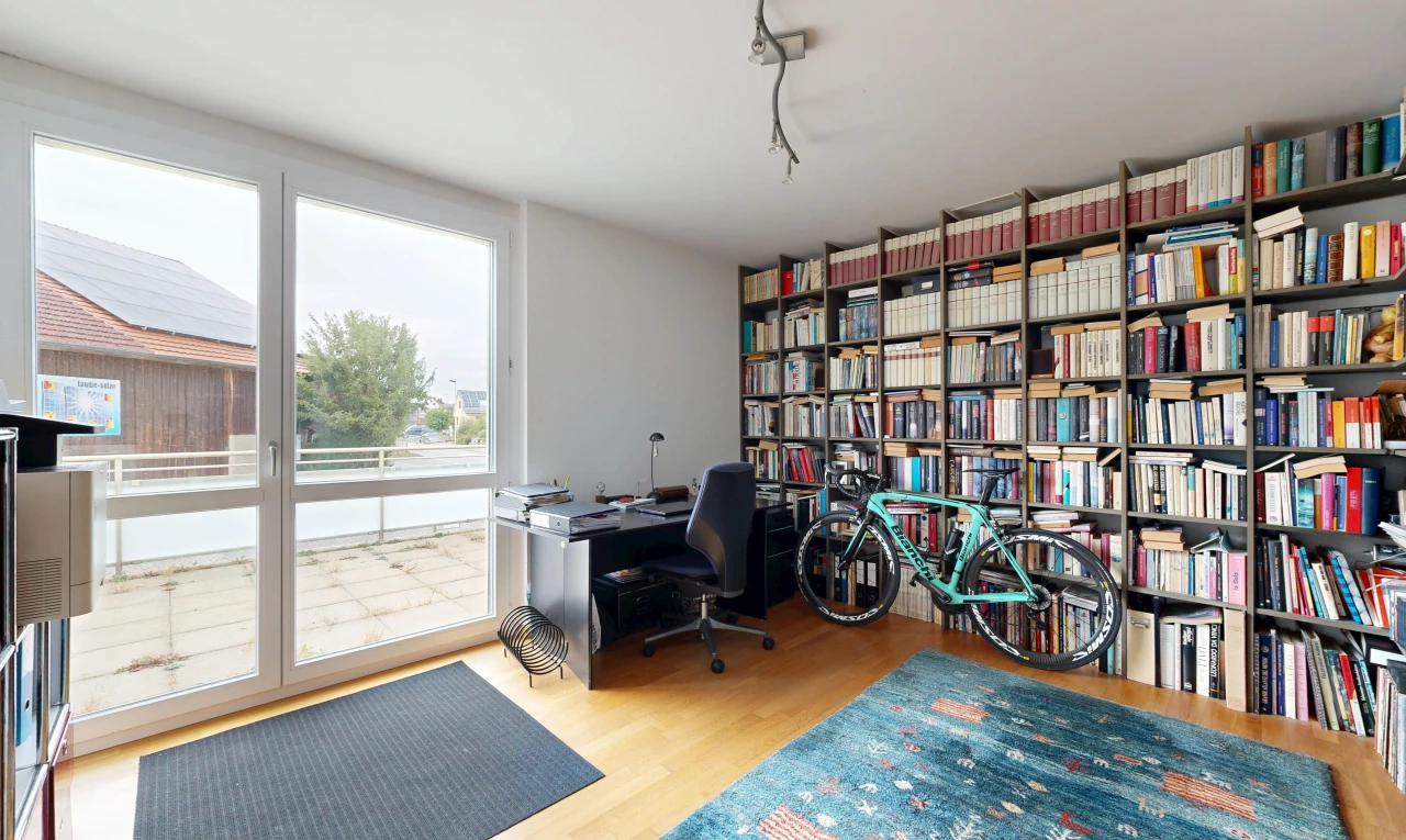 home office with light wood-style flooring, track lighting, and access to outside