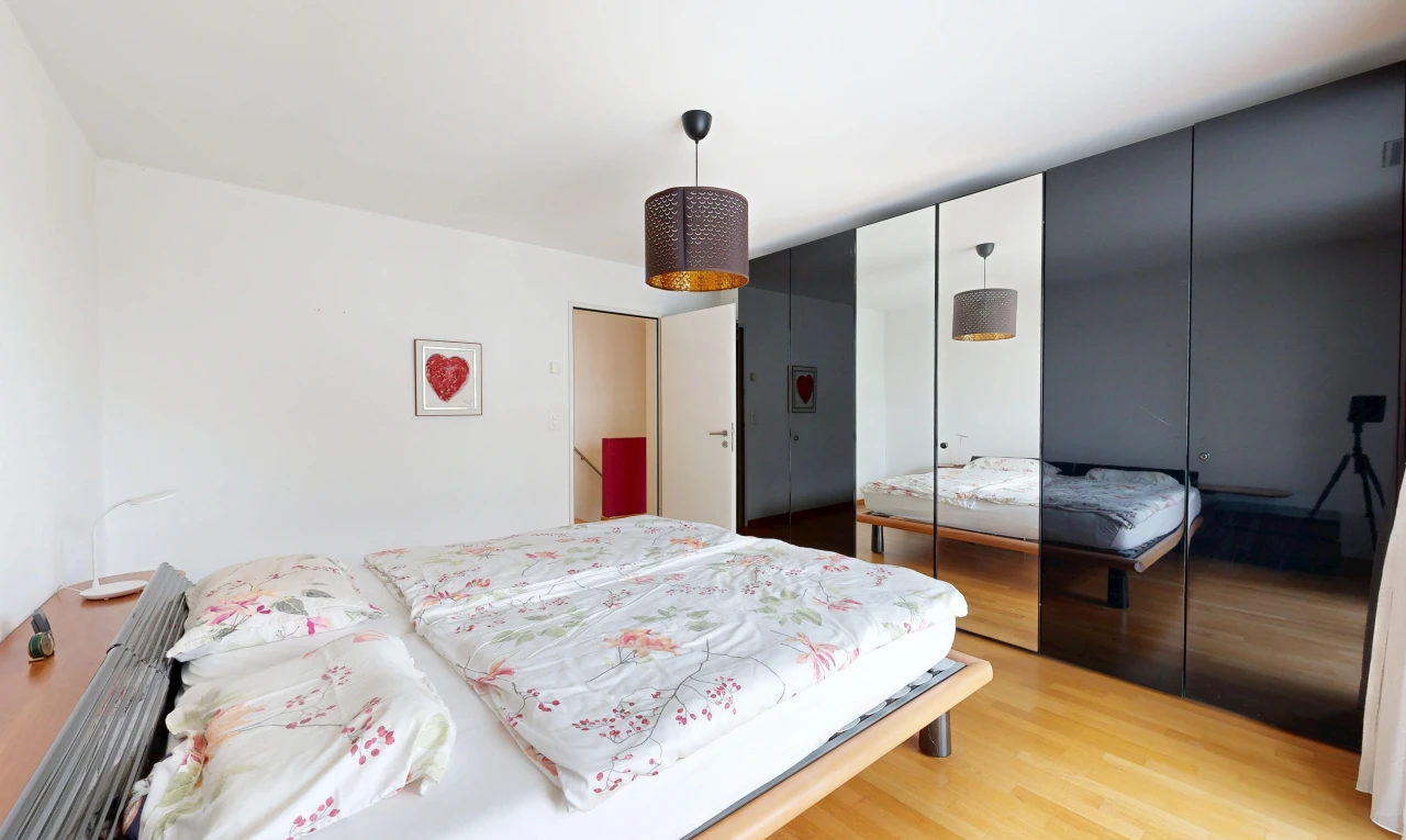room featuring hanging light fixtures, a closet, and light wood-type flooring
