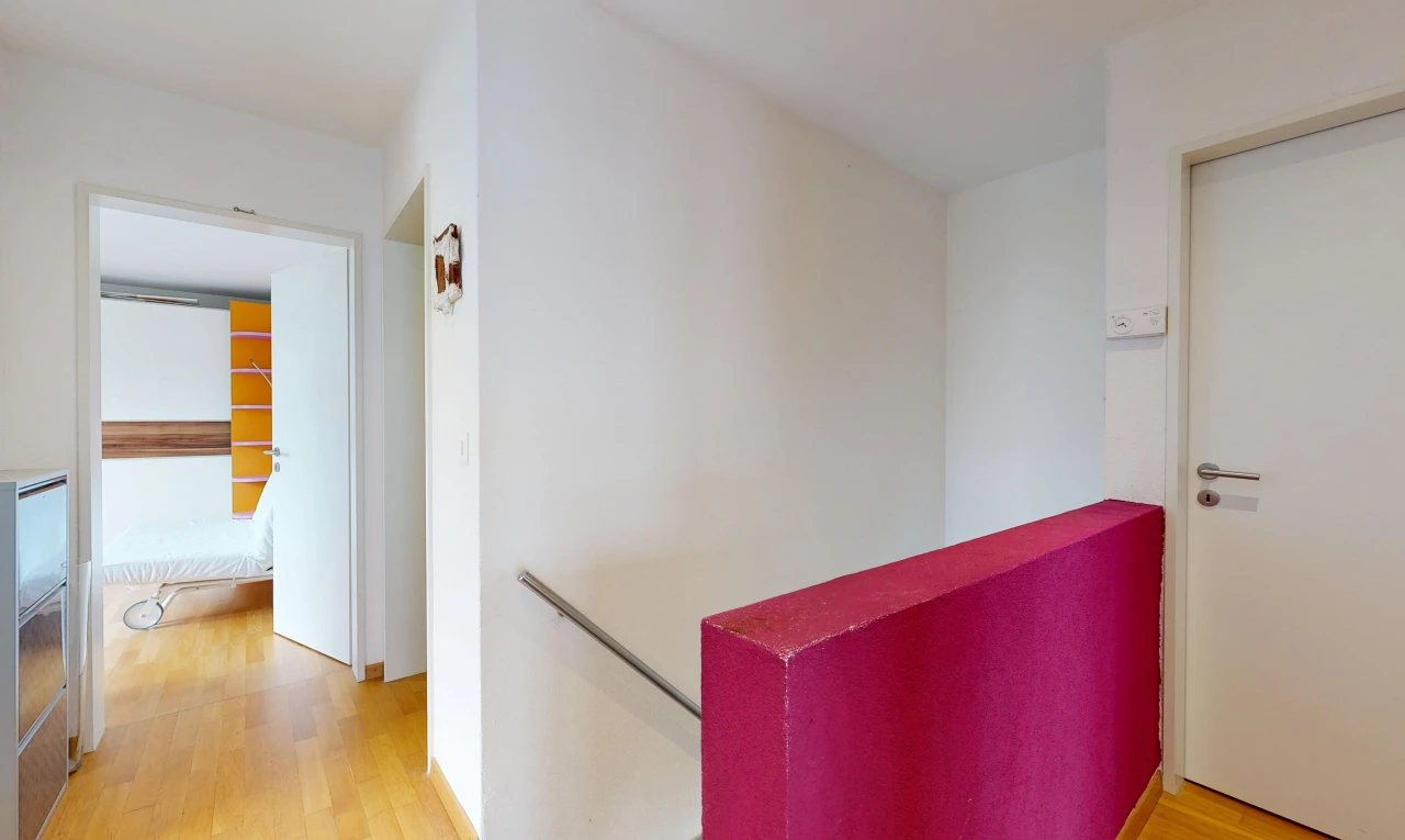 hallway featuring light wood-style floors and an upstairs landing