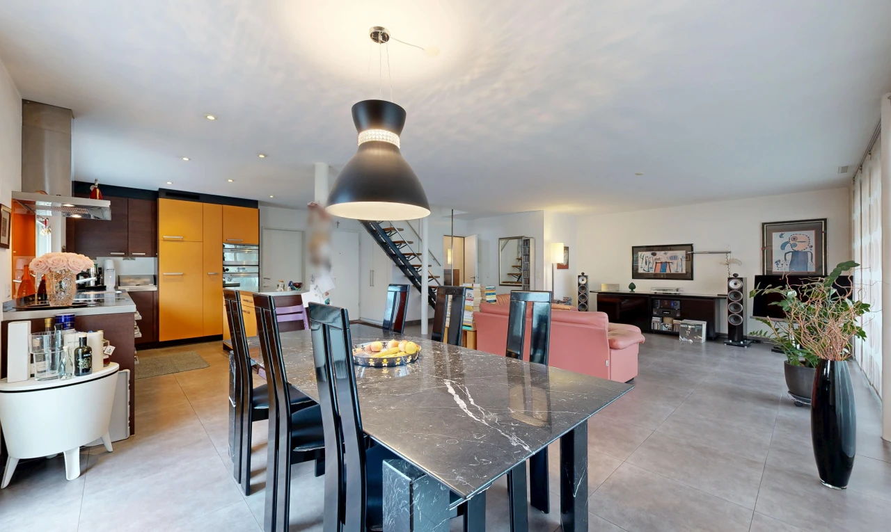 living / dining room featuring stairs and pendant lighting