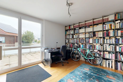 home office with light wood-style flooring, track lighting, and access to outside