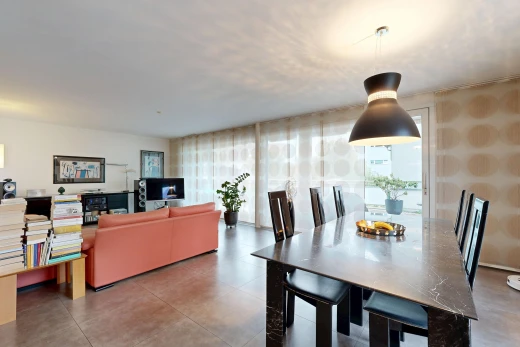 living / dining area with pendant lighting and wallpapered walls