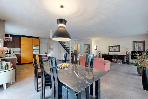living / dining room featuring stairs and pendant lighting