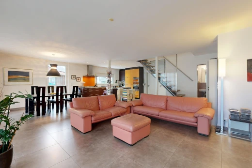 living / dining room featuring stairs