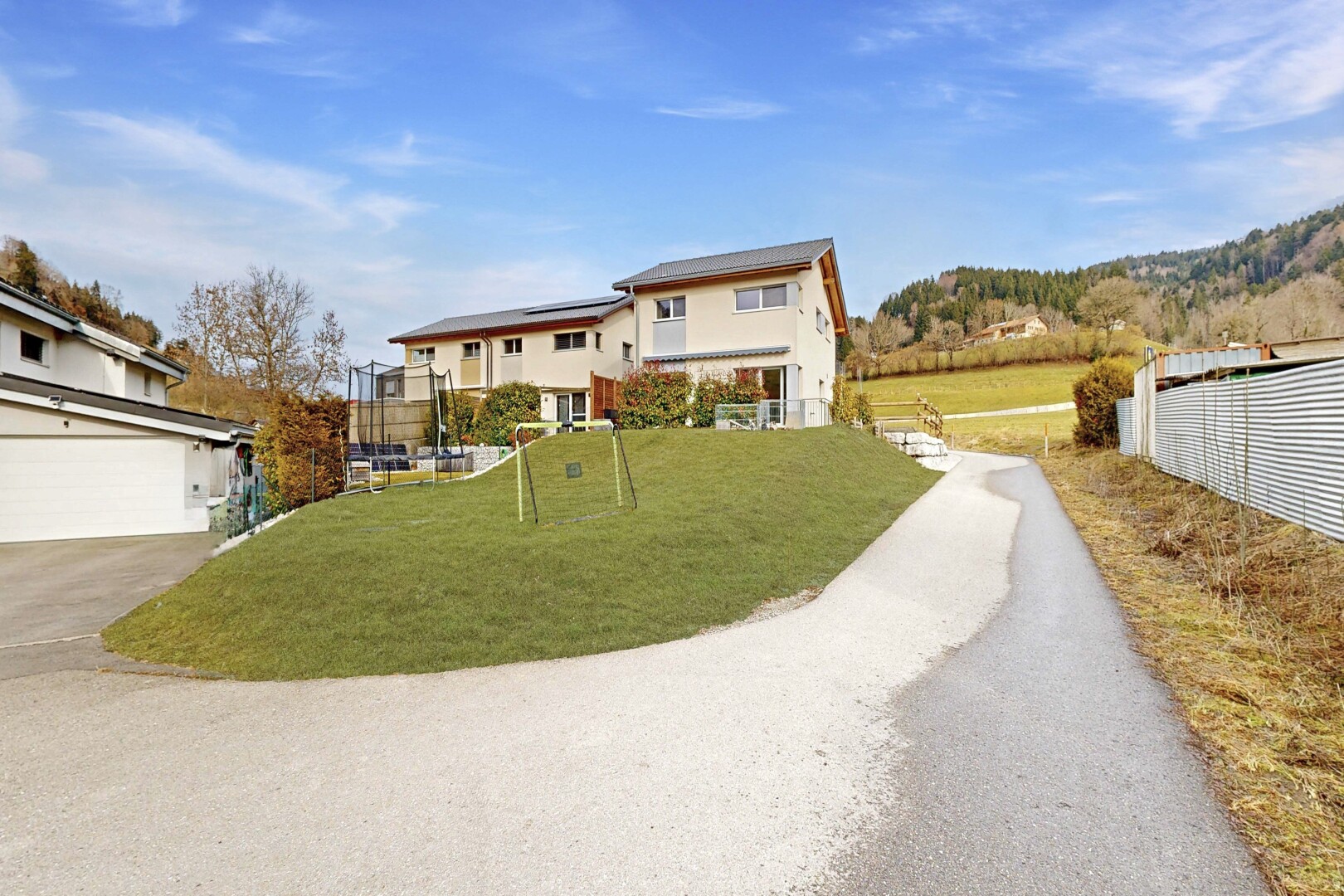 outdoor house featuring roof mounted solar panels