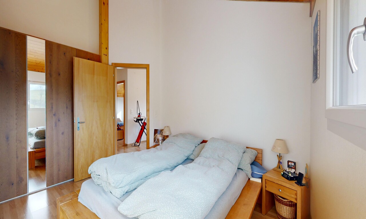 room featuring wood finished floors and a high ceiling