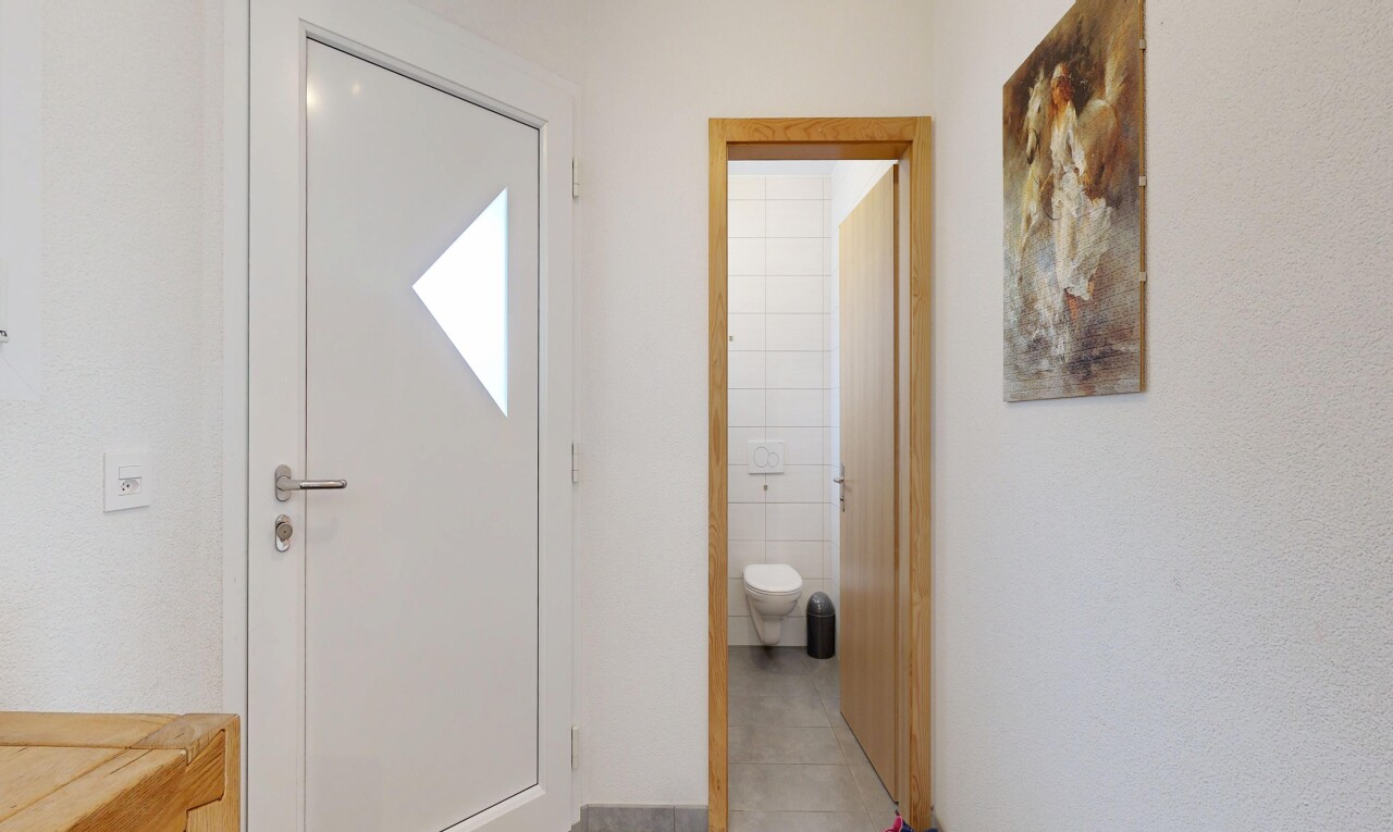 corridor featuring tile walls and light tile patterned flooring