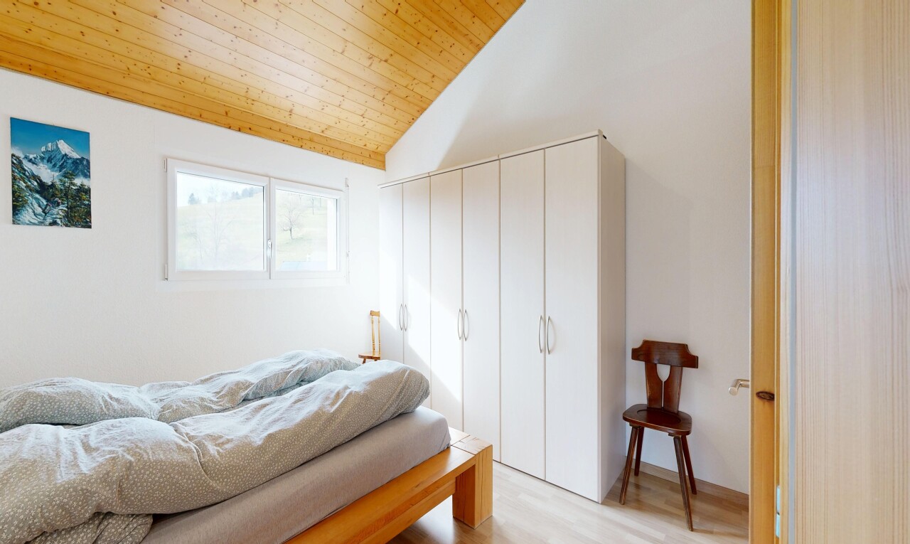 room featuring wood finished floors, a vaulted wooden ceiling, and a closet