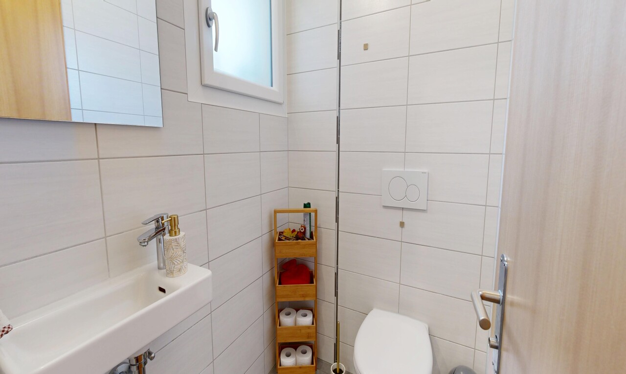 bathroom with a sink and tile walls