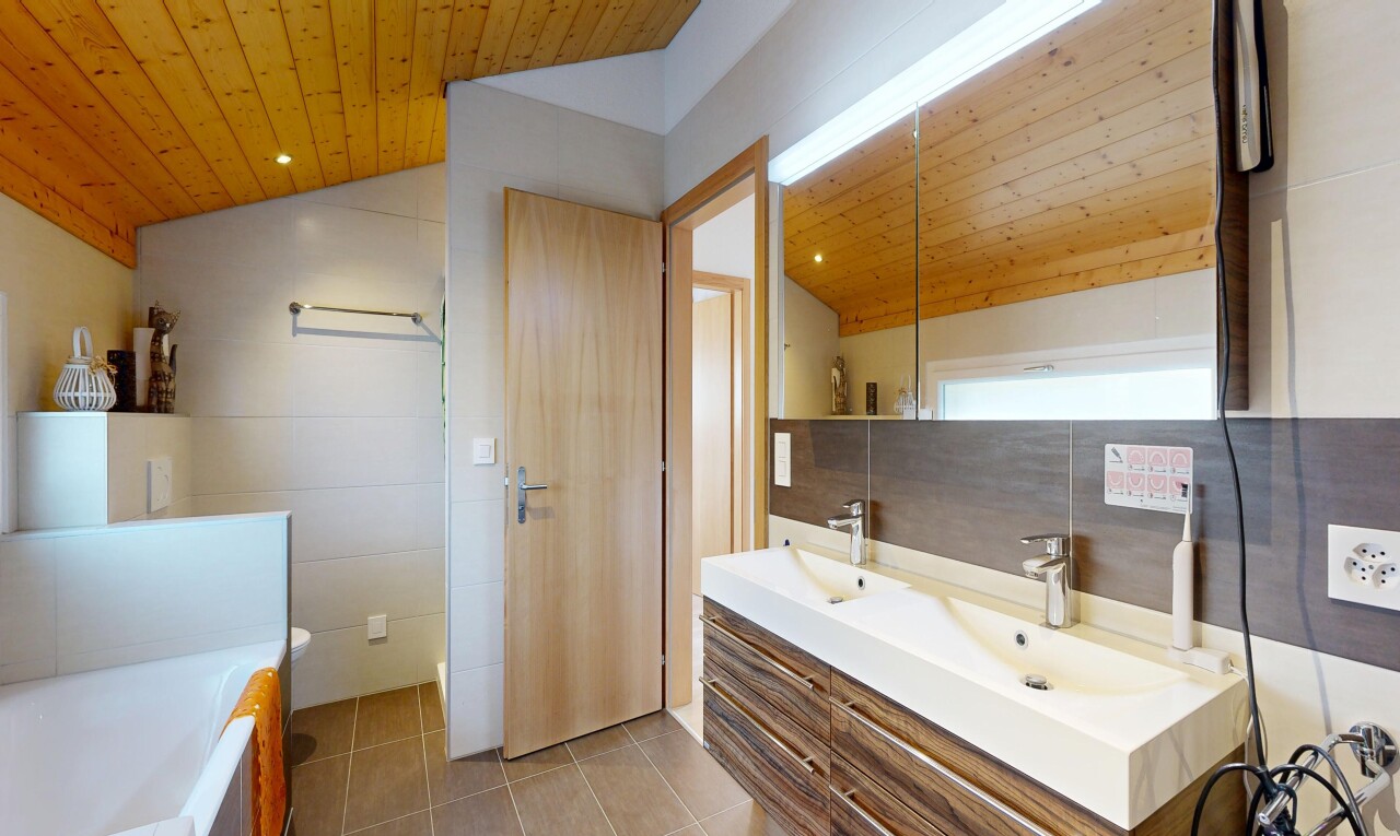 full bath featuring a vaulted wood ceiling, double vanity, tile walls, a bath, and recessed lighting