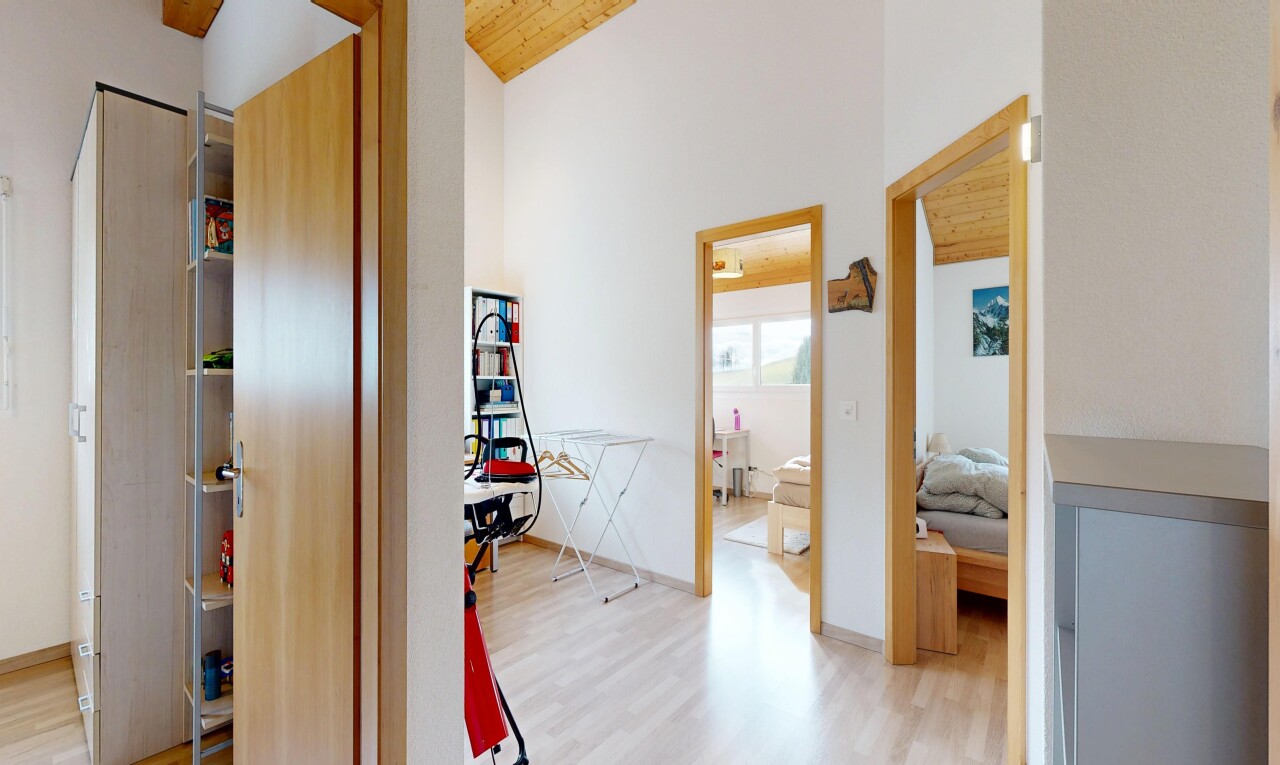 corridor with light wood finished floors and wooden ceiling