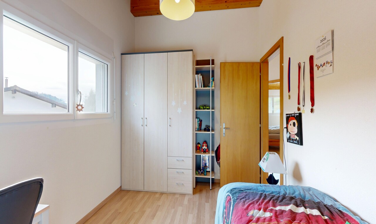 room / bedroom with light wood-style flooring, a closet, and a desk