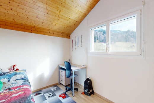 room featuring a vaulted wood ceiling and a desk