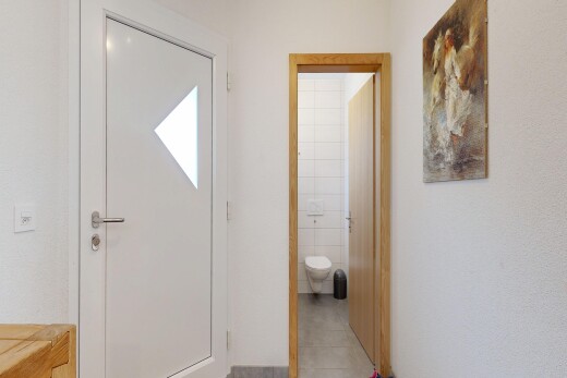 couloir avec lumière naturelle, natural light, inside property, mur en carrelage, et tile wall