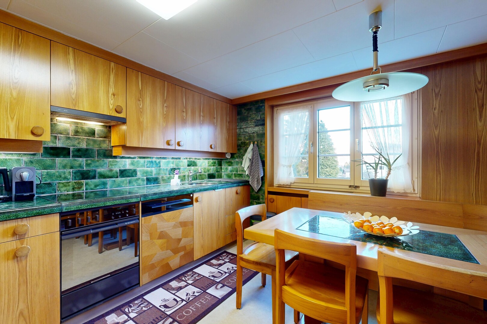 kitchen featuring oven, dark countertops, dishwasher, hanging light fixtures, and backsplash