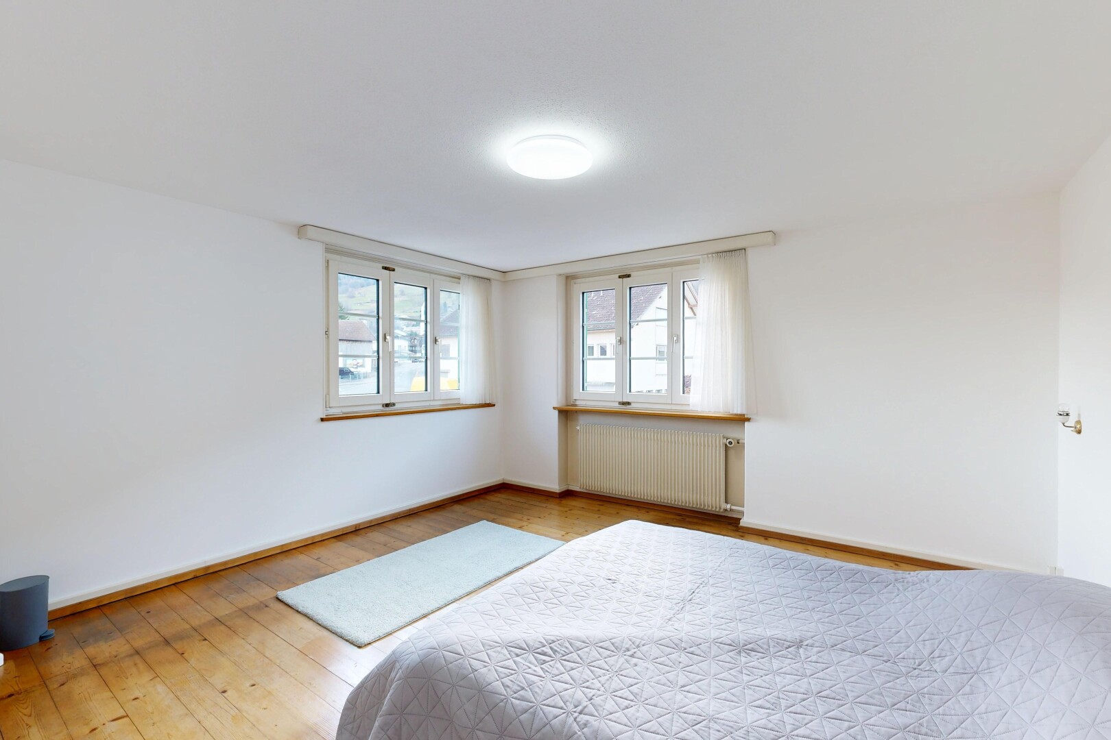 room with radiator and light wood finished floors