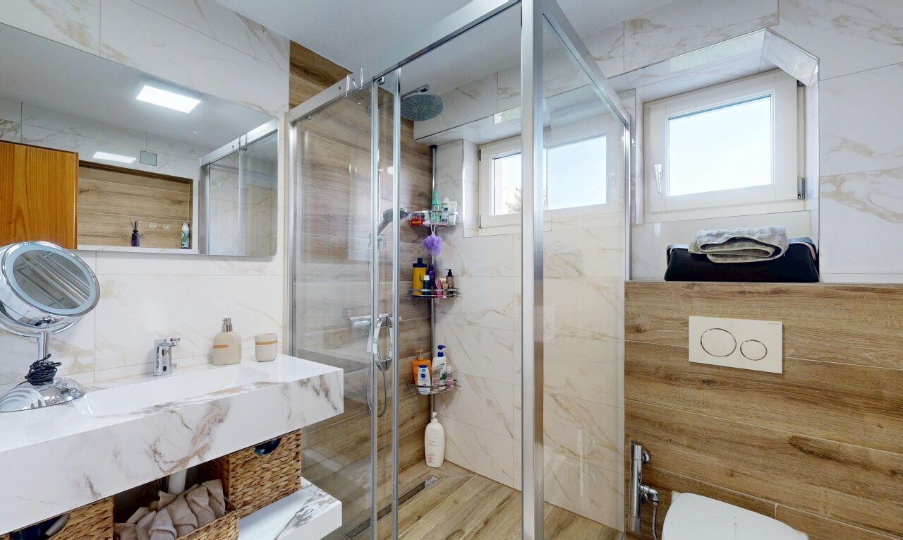 bathroom with vanity and a stall shower