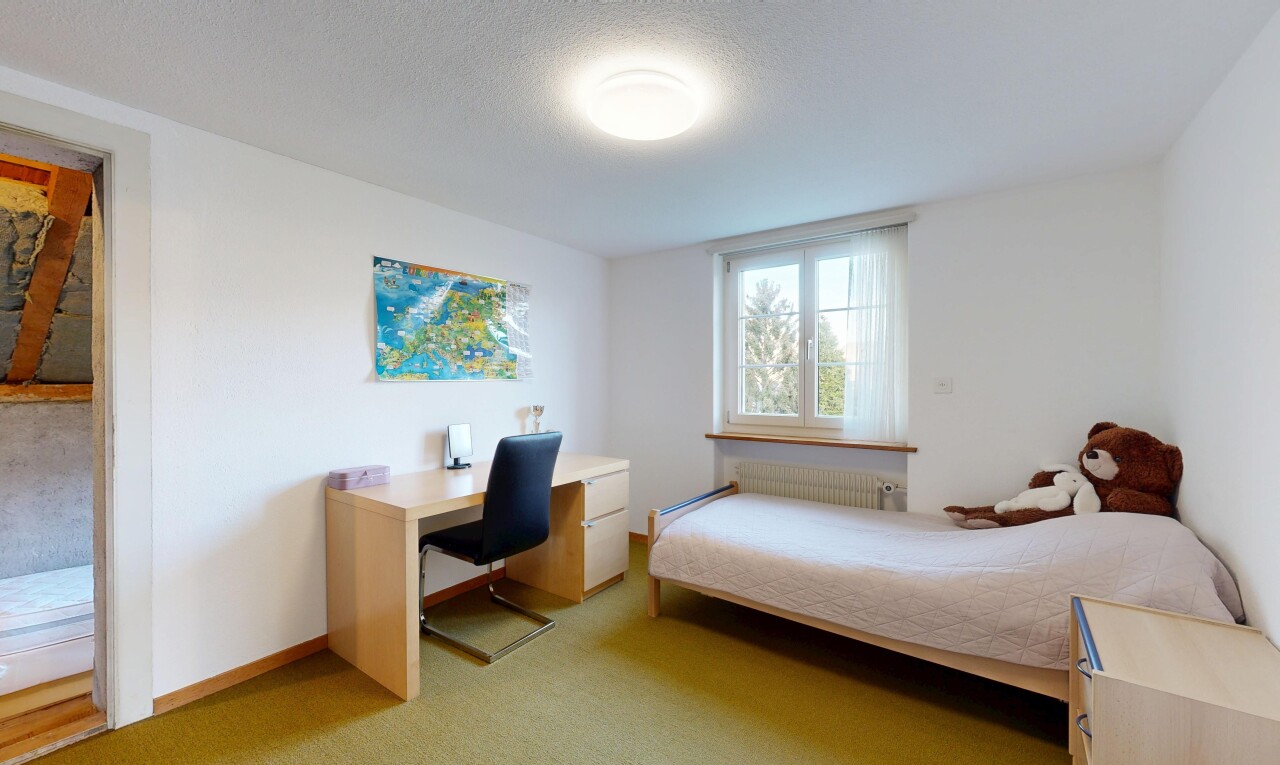 room / bedroom featuring light colored carpet, radiator, a textured ceiling, and a desk