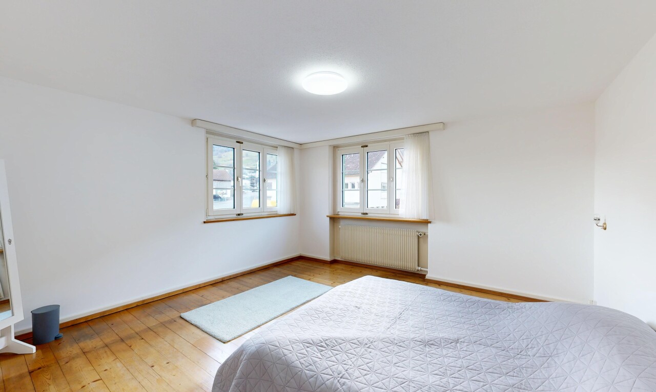 room with radiator and light wood finished floors