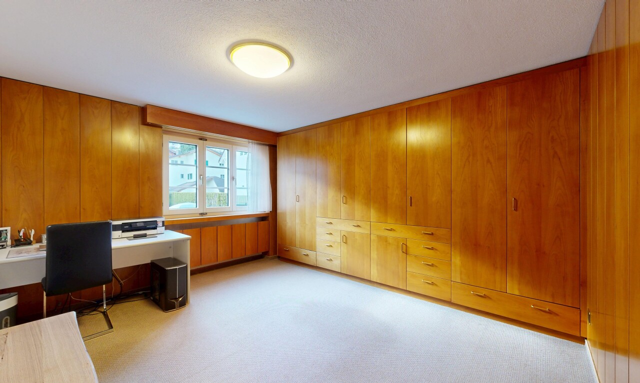room / bedroom featuring a desk, light carpet, a closet, and a textured ceiling