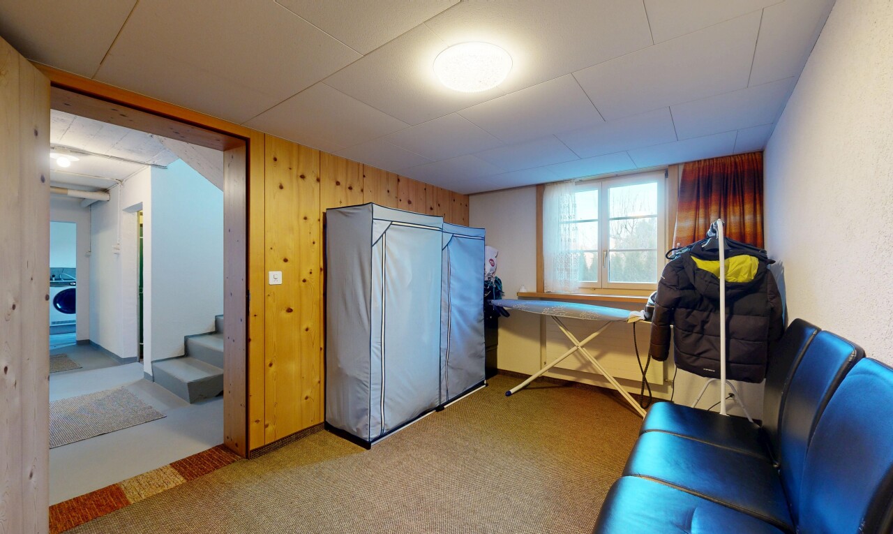 carpeted home office featuring wooden walls and washer / dryer