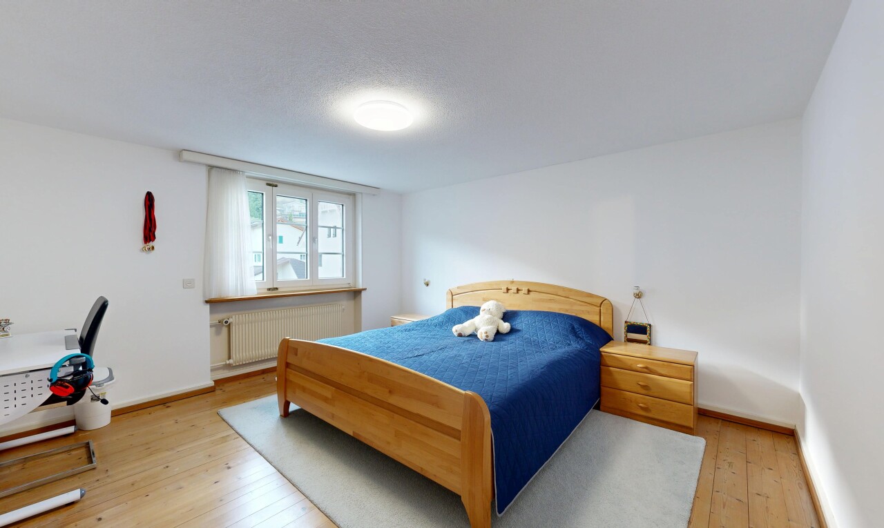 room with radiator, light wood-style flooring, and a textured ceiling
