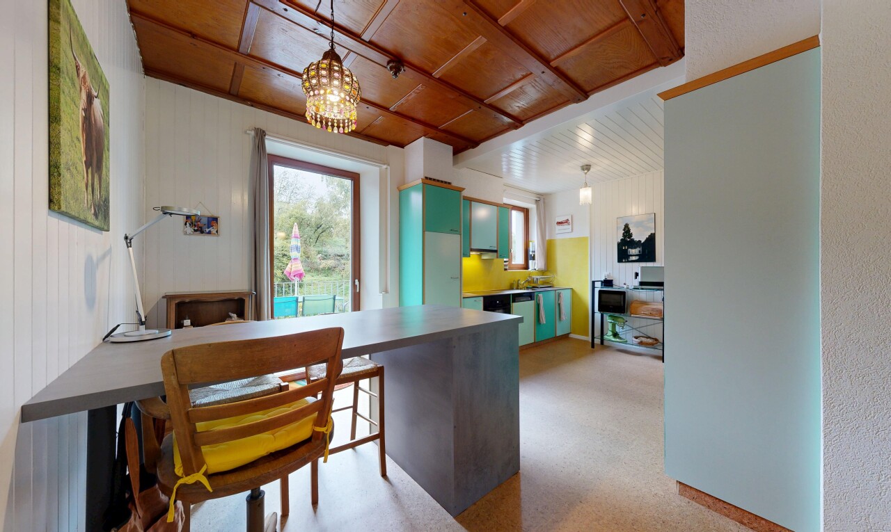 cuisine avec natural light, lumière naturelle, armoires vertes, éclairage suspendu, et inside property