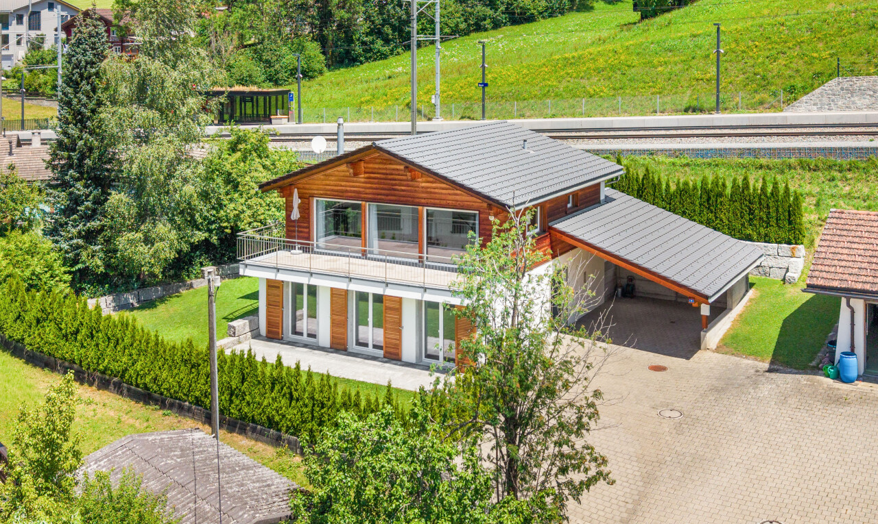 view of home featuring a balcony and driveway