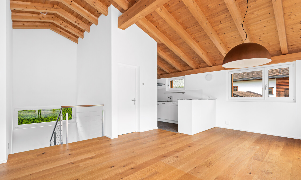 spare room with light wood-style flooring and a high wood beamed ceiling