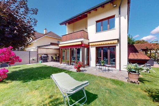 außenansicht mit balkon, property visible, stuckverkleidung, rasen, und day time