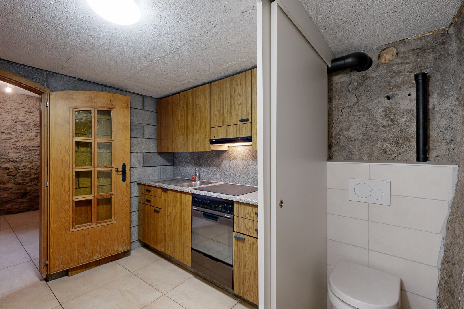 cuisine avec light countertops, plans de travail, four, light floor, et inside property