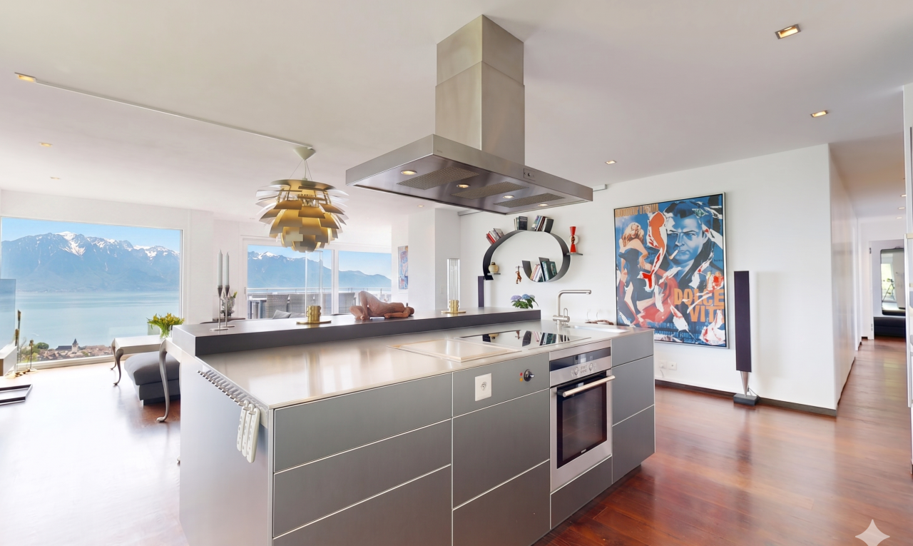 cuisine avec armoires à panneau plat, flat panel cabinets, îlot de cuisine, kitchen island, et hotte