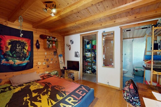chambre avec inside property, wood wall, mur en bois, wood finish floor, et sol en finition bois