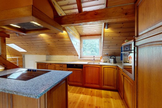 küche mit mittelbraune schränke, herd, inside property, dachfenster, und dunstabzugshaube