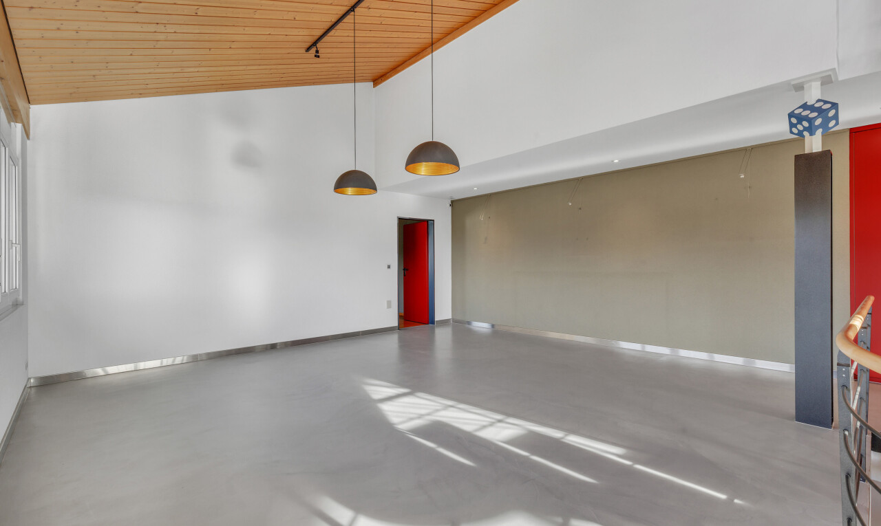 empty room featuring finished concrete flooring, high vaulted ceiling, and wood ceiling