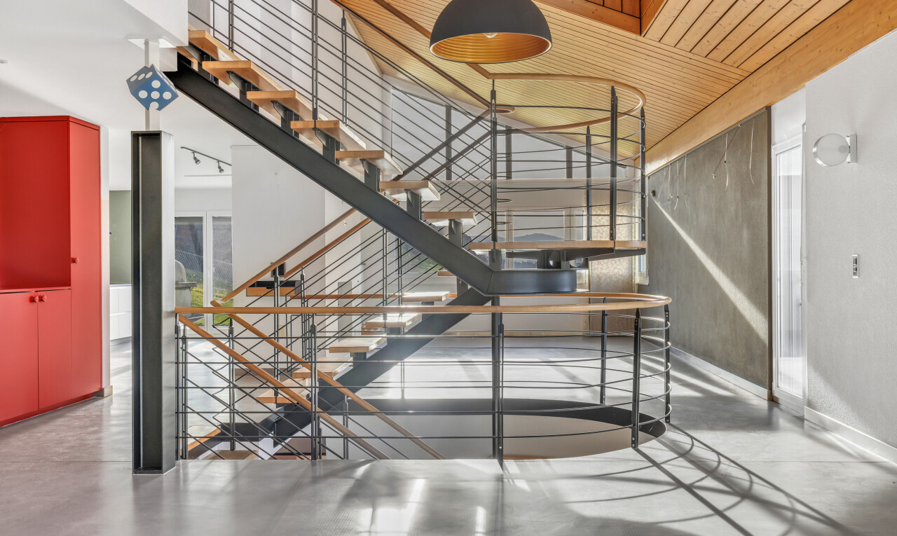 staircase with concrete flooring and wood ceiling