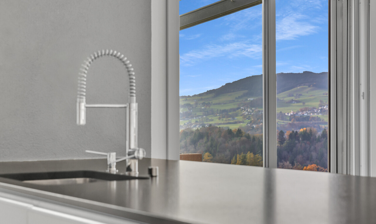 kitchen view of a mountain backdrop and dark countertops