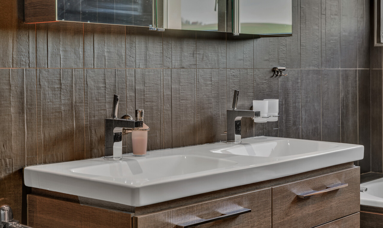 bathroom view of vanity and tiled bath