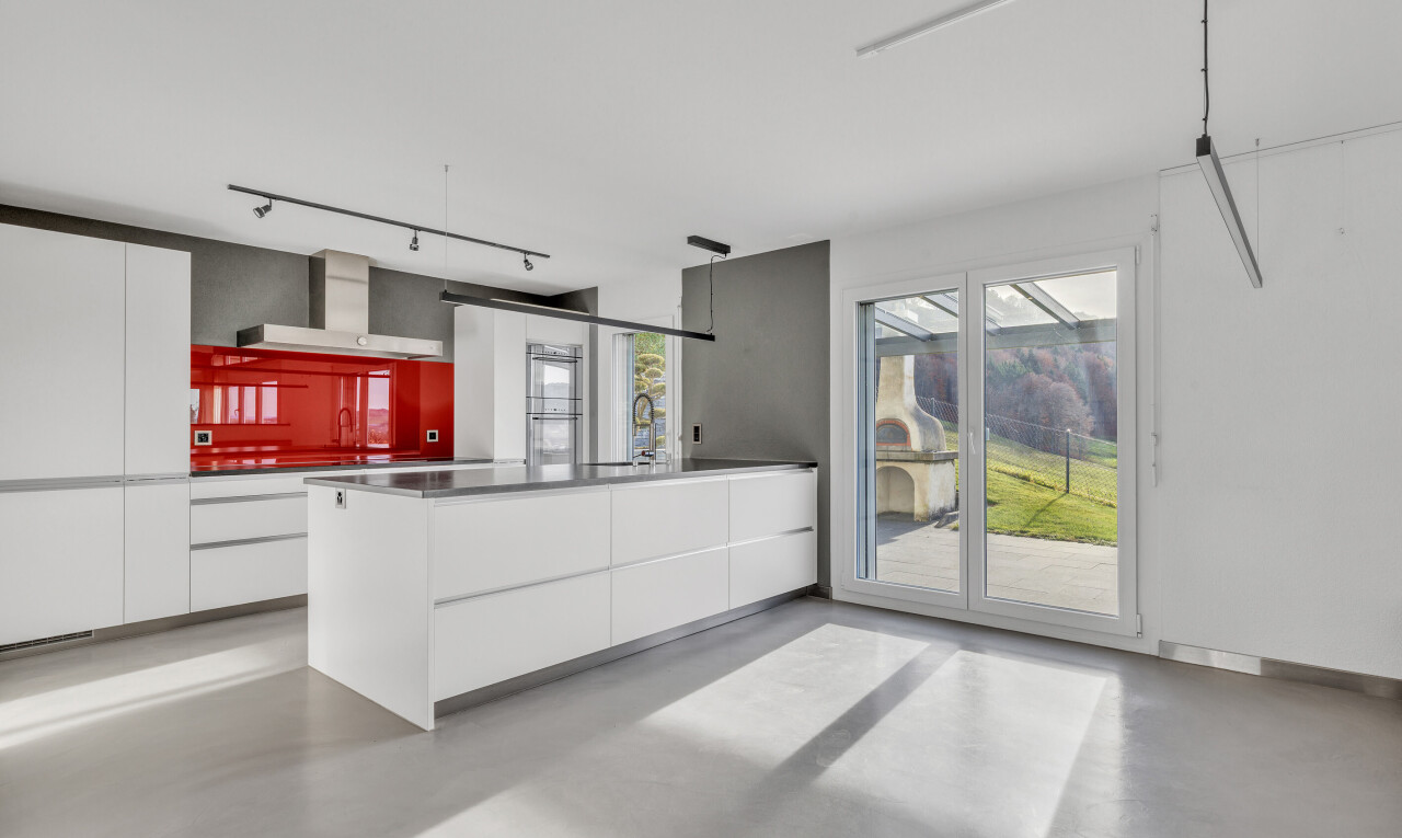 kitchen featuring modern cabinets, white cabinetry, and finished concrete flooring
