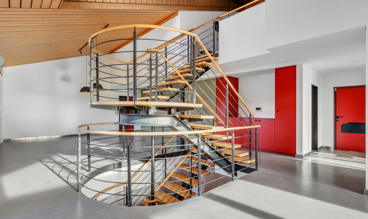 stairs featuring finished concrete floors and wood ceiling
